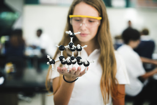 Student holding chemical model in private high school in toronto